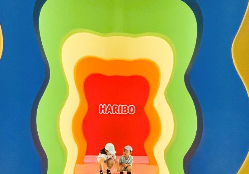 Kids posing in front of the HARIBO Happy World character